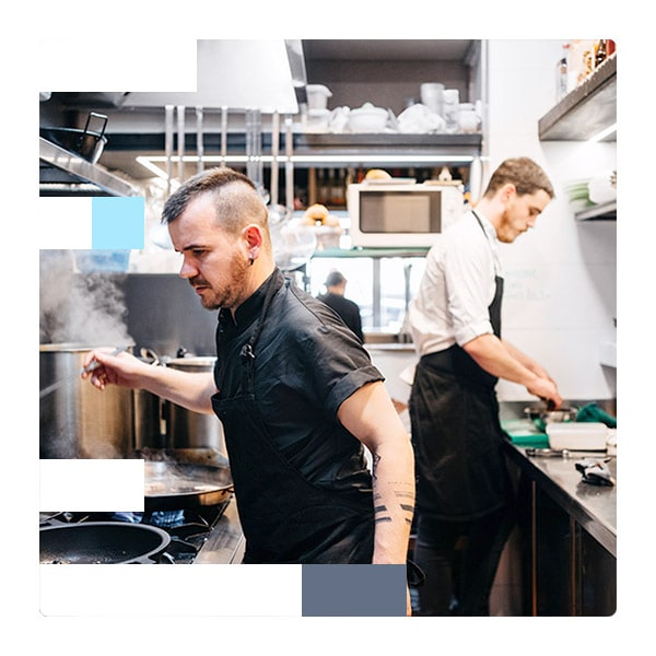Two chefs cooking in a kitchen